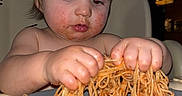 Matthew is registered to the contest to win money with this photo: child, baby, spaghetti, food, messy, plate, hands, sauce, meal, highchair, indoors, dining, cute, face, expression, hair, table, eating, concentration, toddler