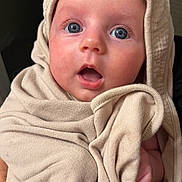 Navy is registered to the contest to win money with this photo: baby, infant, face, eyes, expression, blanket, cloth, hood, skin, person, closeup, cute, newborn, soft, wrapped, surprised, indoors, portrait, human, child