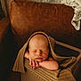 Stetson is registered to the contest to win money with this photo: baby, newborn, sleeping, blanket, box, wood, cozy, brown, knit, infant, cute, portrait, peaceful, soft_lighting, indoors, resting, child, wrapped, warm, relaxing