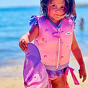 Margaux a rejoint le concours — aidez-le/la à gagner de superbes lots ! beach, beachwear, child, clothing, coast, face, female, girl, head, lifejacket, nature, outdoors, person, photography, portrait, sea, shoreline, swimwear, vest, water