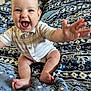 baby, bed, blanket, child, clothing, cute, face, feet, hand, happy, indoor, infant, joyful, pattern, person, portrait, reaching, sitting, smiling, young