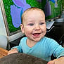 baby, baby_boy, baby_girl, blue_clothing, bunny, cartoon, child, cute, face, furniture, hand, happy, indoor, infant, light, portrait, room, smiling, table, television