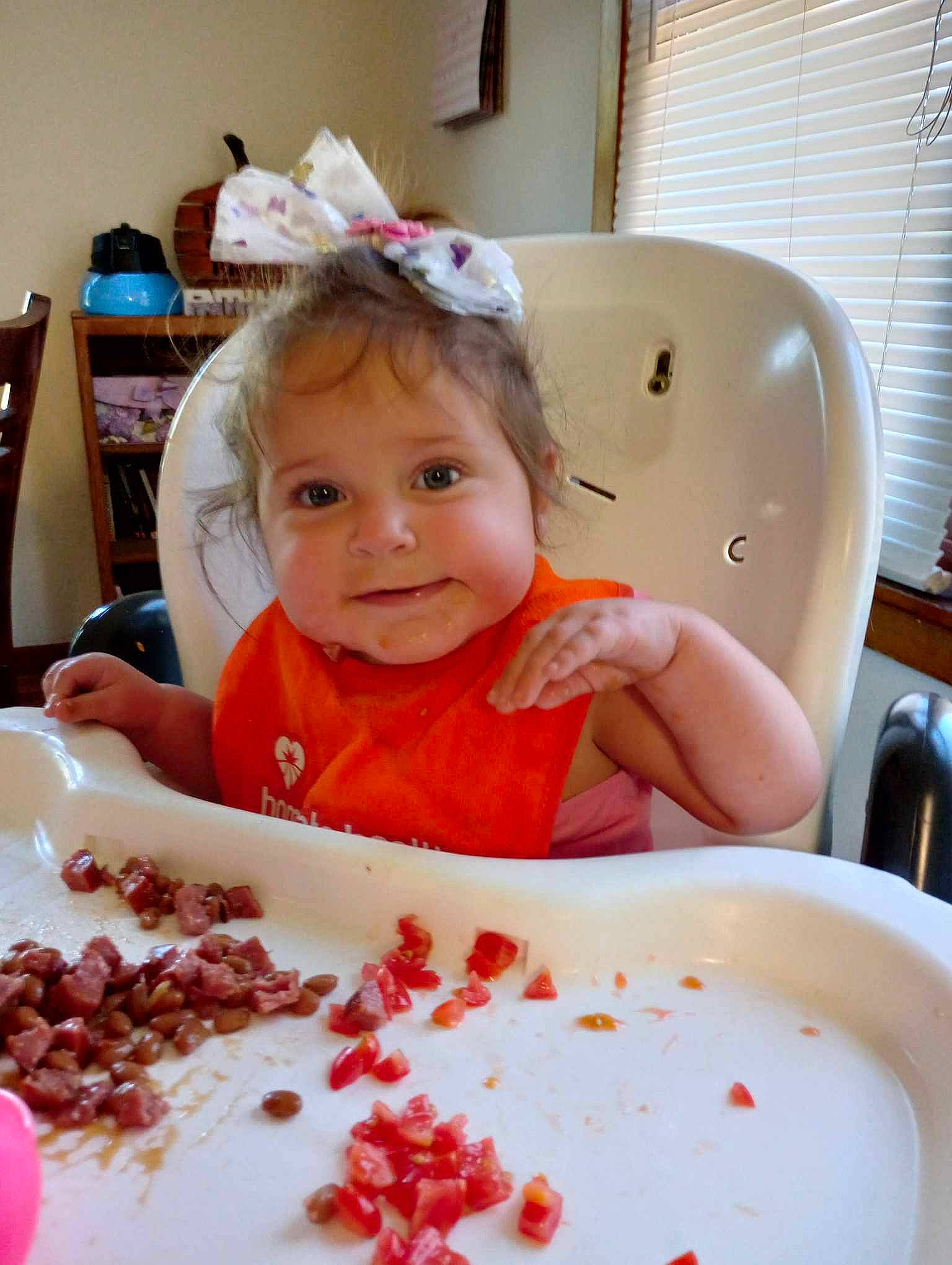 Elissa is registered to the contest to win money with this photo: baby, baby_toddler_clothing, chair, child, comfort_food, cuisine, dish, food, happy, ingredient, joy, natural_foods, person, plant, produce, recipe, smile, sweetness, table, tableware