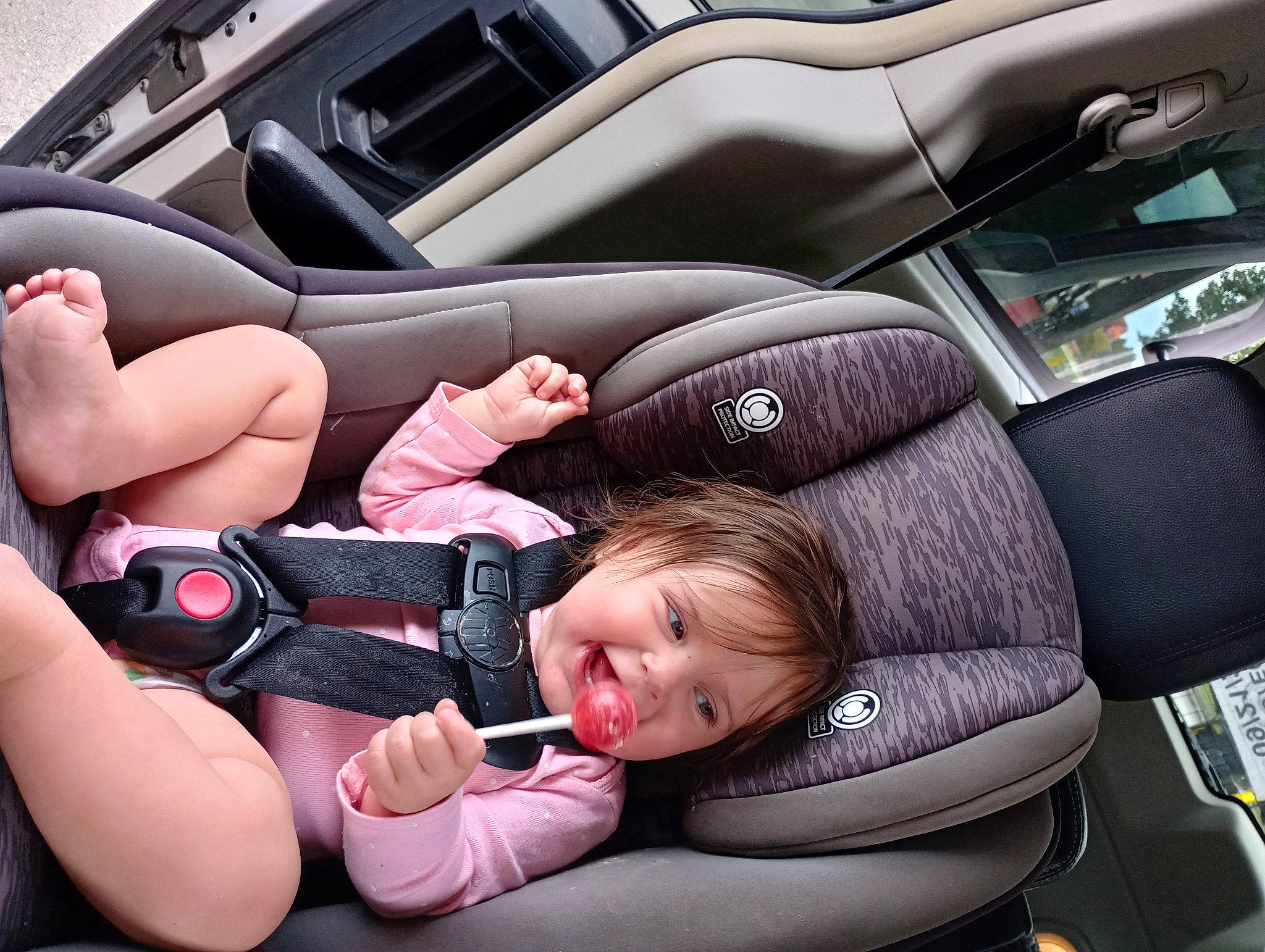 Elissa is registered to the contest to win money with this photo: auto_part, automotive_design, automotive_exterior, baby_in_car_seat, car, car_seat, car_seat_cover, comfort, gear_shift, gesture, head_restraint, motor_vehicle, person, personal_luxury_car, seat_belt, steering_part, steering_wheel, thumb, toddler, vehicle