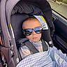 Charles joined the competition — help win amazing prizes! baby, car_seat, sunglasses, blanket, child, seatbelt, car_interior, window, person, portrait, cool, child_in_car, infant, clothing, face, seat, car, safety, sunlight, reflection