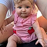 baby, child, infant, pink_clothing, flower_headband, strawberry_patch, cute, chubby, portrait, person, skin, hand, legs, outdoor, adult_support, closeup, expression, sitting, casual, warm_light
