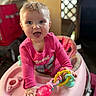 baby, child, pink_clothing, walker, toy, smile, happy, indoor, infant, cute, person, playtime, colorful, young_child, toddler, face, hand, expression, bright, seat