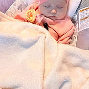 Angel is registered to the contest to win money with this photo: baby, sleeping, blanket, pink_bow, baby_seat, cozy, infant, cute, headband, soft_texture, peaceful, child, indoors, comfort, clothing, rest, wrapped, adorable, face, young