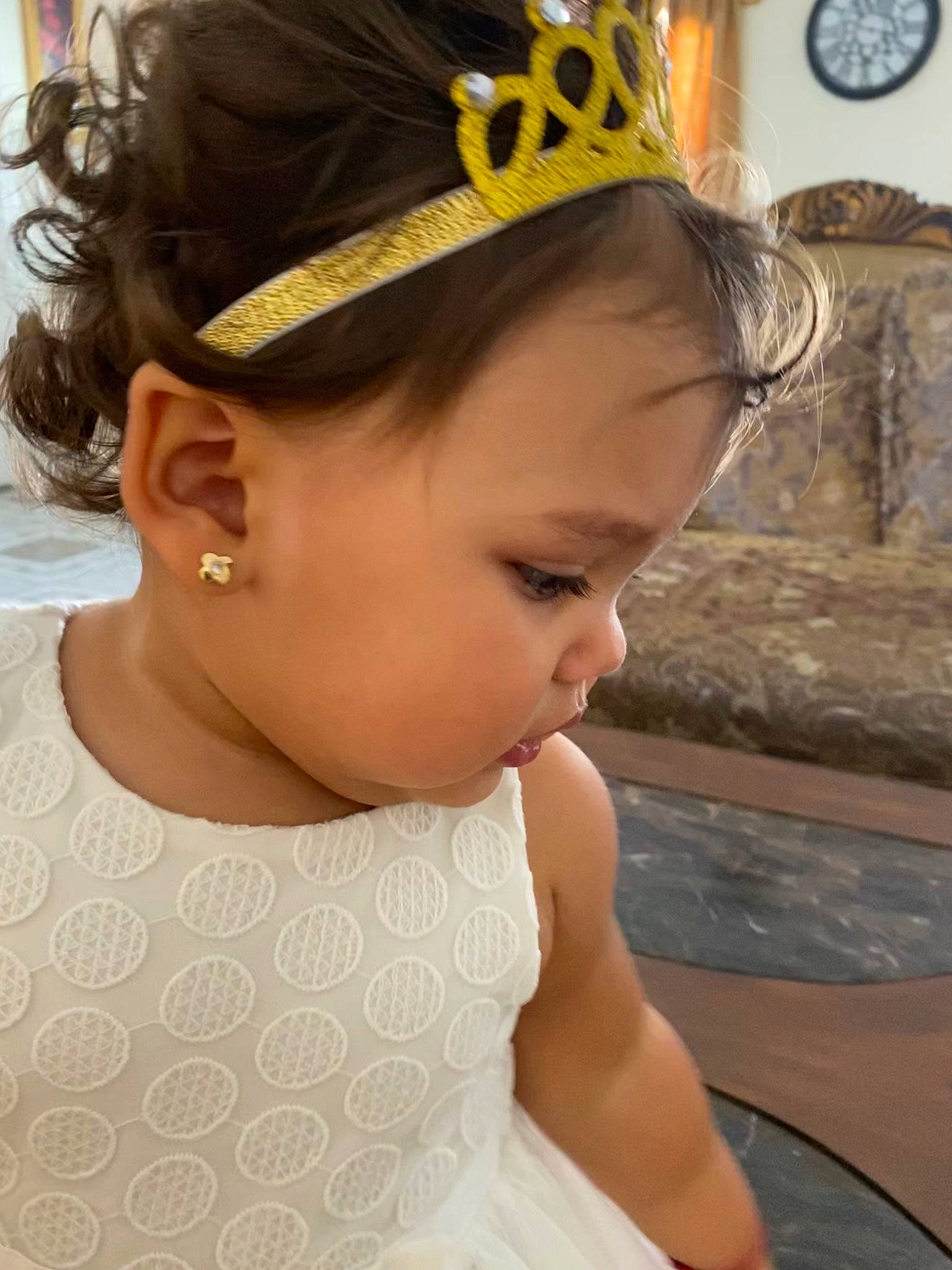 Brittany is registered to the contest to win money with this photo: baby, child, clothing, crown, ear, fashion_accessory, forehead, hair, hair_accessory, hair_tie, head, headband, headgear, headpiece, person, tiara, toddler, yellow