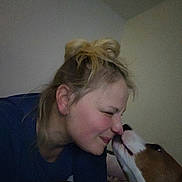 Chippy joined the competition — help win amazing prizes! affection, bedroom, close_up, cuddle, dog, face, fur, hair_bun, human, indoor, kiss, light_shadow, lying_down, muzzle, nose_touch, person, pet, smiling, wholesome, woman