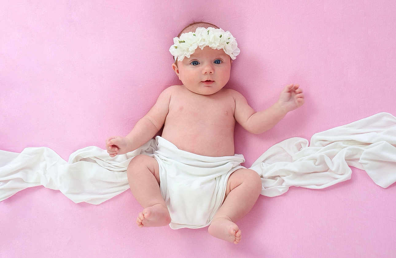 Nevaeh-Leigh joined the competition — help win amazing prizes! baby, infant, flower_crown, pink_background, white_cloth, naked_torso, cute, child, portrait, lying_down, soft_texture, skin, small_feet, small_hands, innocent, adorable, fresh, newborn, studio_photo, peaceful