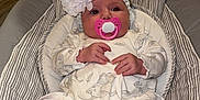 Nevaeh-Leigh is registered to the contest to win money with this photo: baby, infant, pacifier, headband, flower, onesie, socks, baby_seat, striped, indoor, floor, door, cushion, cute, child, person, newborn, resting, clothing, footwear