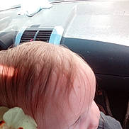 Esme joined the competition — help win amazing prizes! car_interior, casual, child, close_up, clothing, cute, dashboard, flower, hair, indoors, natural_light, overexposed, person, profile, seat, side_view, skin, toy, window, young_child