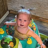Esme is registered to the contest to win money with this photo: baby, carpet, child, colorful, curious, cute, floor, home, indoor, infant, looking_up, person, pigtails, play, seat, small_child, toy, vacuum_cleaner, walker, wood_floor