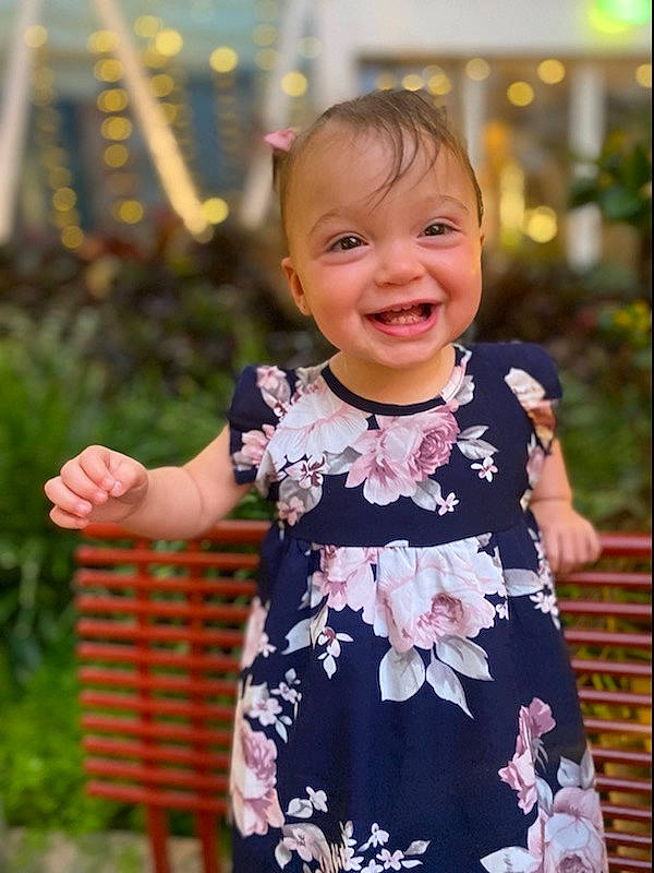 Delilah joined the competition — help win amazing prizes! arm, baby, baby_toddler_clothing, dress, eye, face, gesture, grass, hand, happy, head, joy, leaf, people_in_nature, person, plant, skin, sleeve, smile, standing