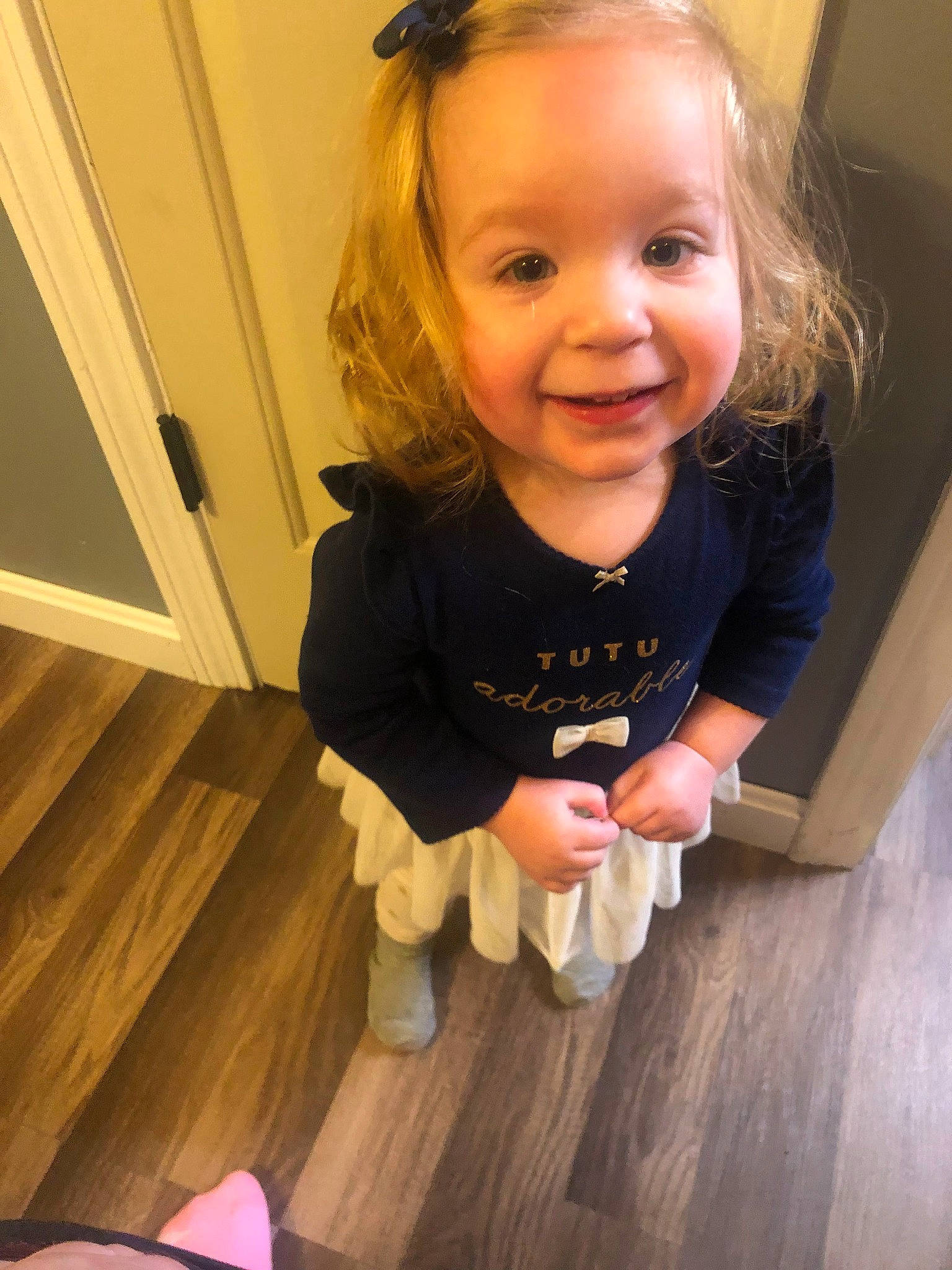 Primrose is registered to the contest to win money with this photo: baby_toddler_clothing, cheek, eye, facial_expression, finger, floor, flooring, fun, happy, hardwood, iris, joy, laminate_flooring, nose, person, skin, smile, thumb, toddler, varnish