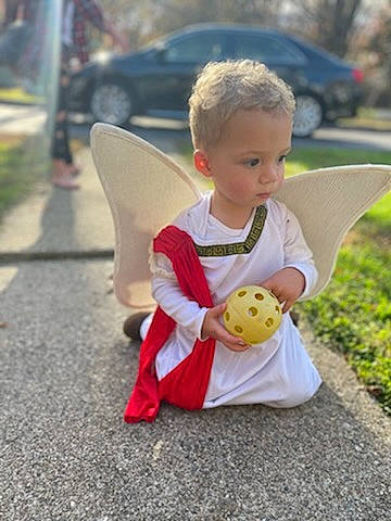 Sean is registered to the contest to win money with this photo: asphalt, baby, baby_products, car, child, facial_expression, fun, grass, happy, lap, leisure, person, plant, play, recreation, road, sitting, toddler, toy, tree