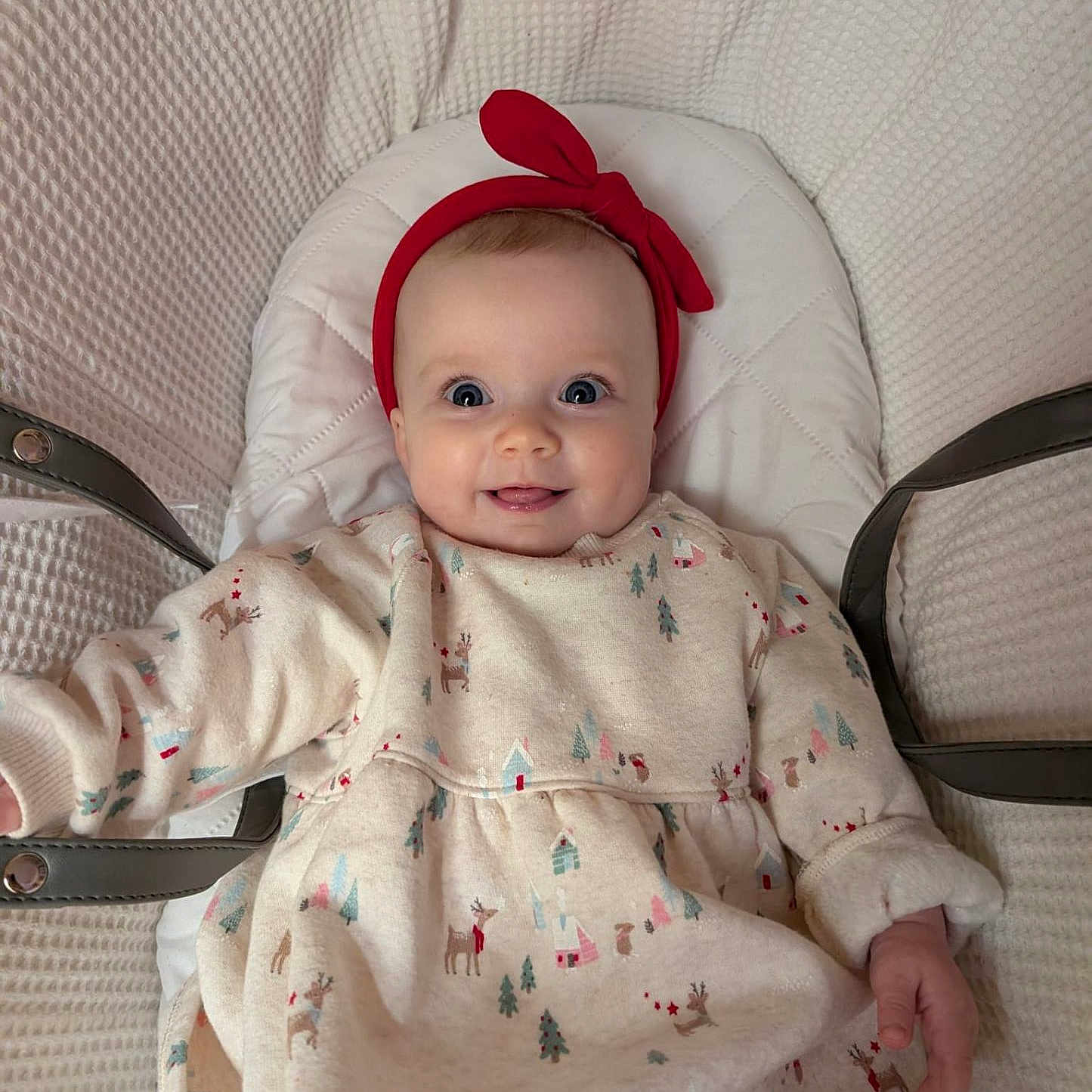 Rosie is registered to the contest to win money with this photo: apparel, baby, child, comfort, cozy, cushion, cute, dress, happy, headband, indoor, infant, patterned_clothing, person, portrait, red, seat, smile, warm, young