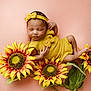 Isla joined the competition — help win amazing prizes! newborn, baby, sleeping, yellow_outfit, headband, sunflowers, flowers, soft_background, peaceful, infant, cute, portrait, closeup, child, floral, adorable, resting, skin, hands, feet