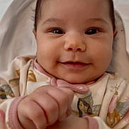 Angeline is registered to the contest to win money with this photo: baby, bed, blanket, cheeks, child, cozy, cute, eyes, face, floral_pattern, hands, happy, human, indoors, infant, onesie, portrait, skin, smile, young