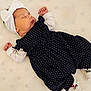 baby, newborn, sleeping, dress, polka_dot, headband, bow, white, navy_blue, blanket, infant, cute, peaceful, lying_down, clothing, soft, child, portrait, indoors, resting