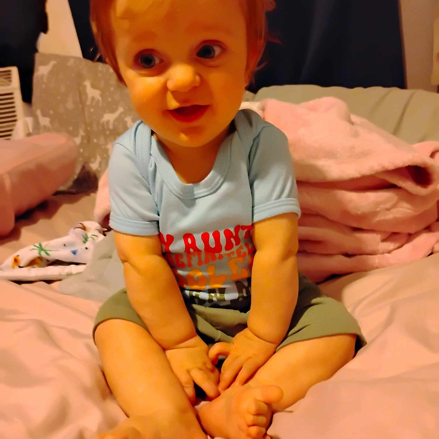 Elijah joined the competition — help win amazing prizes! barefoot, bed, blanket, child, clothing, cute, face, hair, happy, indoors, person, pillow, shirt, shorts, sitting, skin, smiling, soft, toddler, young