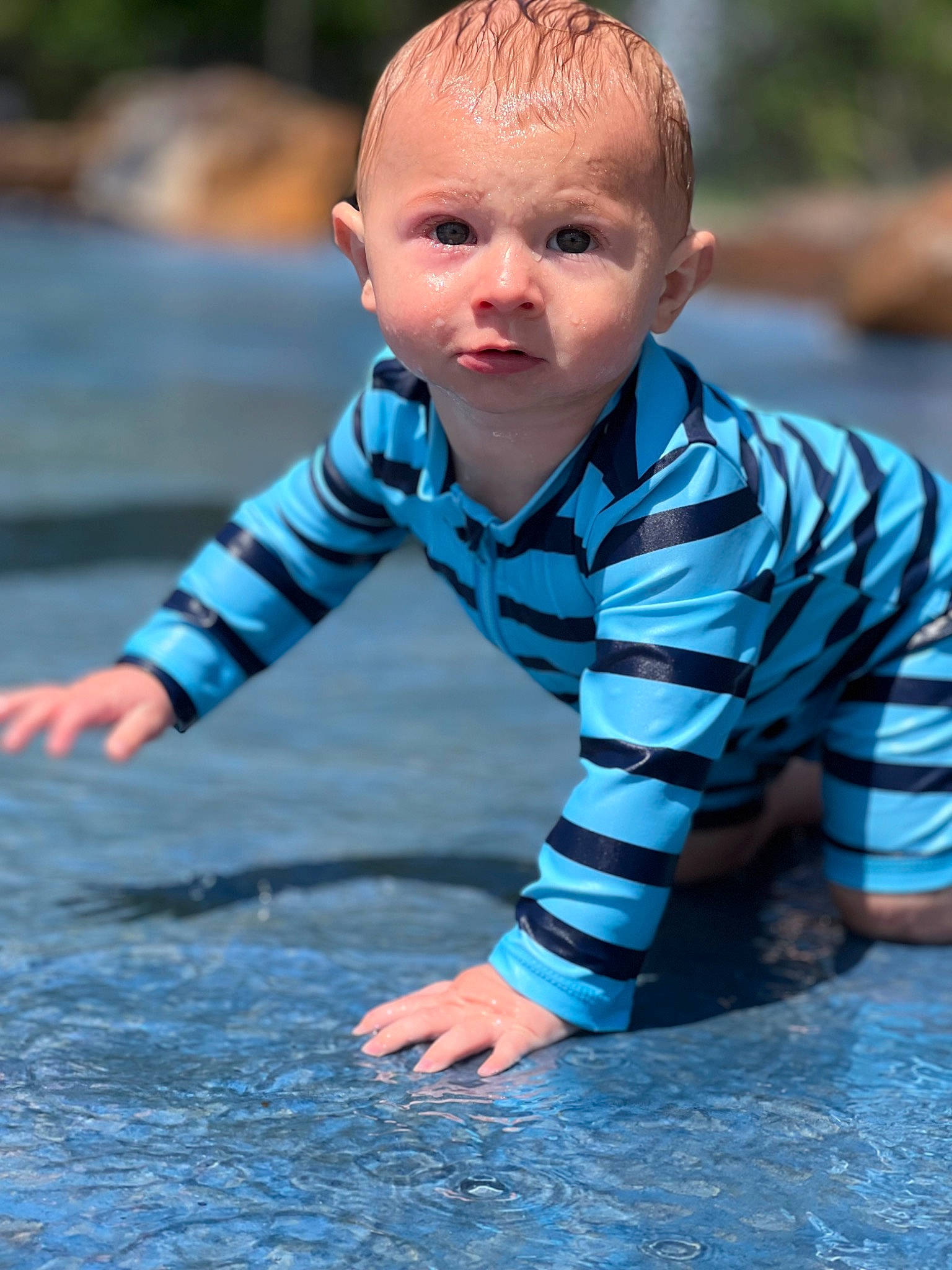 Paxton is registered to the contest to win money with this photo: asphalt, azure, baby, baby_toddler_clothing, blue, crawling, face, flooring, grass, happy, head, leg, leisure, people_in_nature, person, photograph, skin, smile, toddler, water