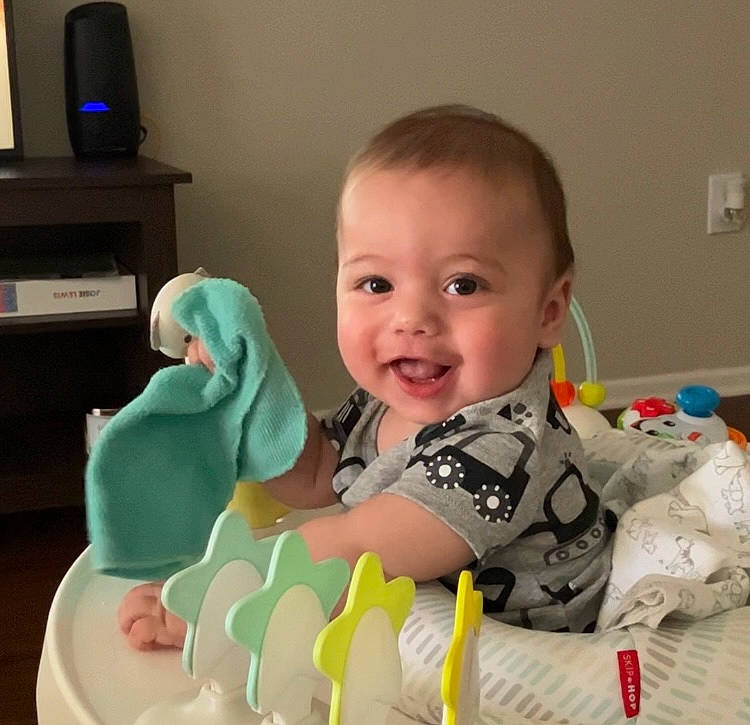 Owen is registered to the contest to win money with this photo: baby, baby_products, baby_safety, baby_toddler_clothing, cheek, child, comfort, finger, fun, happy, head, joy, mouth, person, room, sitting, sleeve, smile, t_shirt, textile