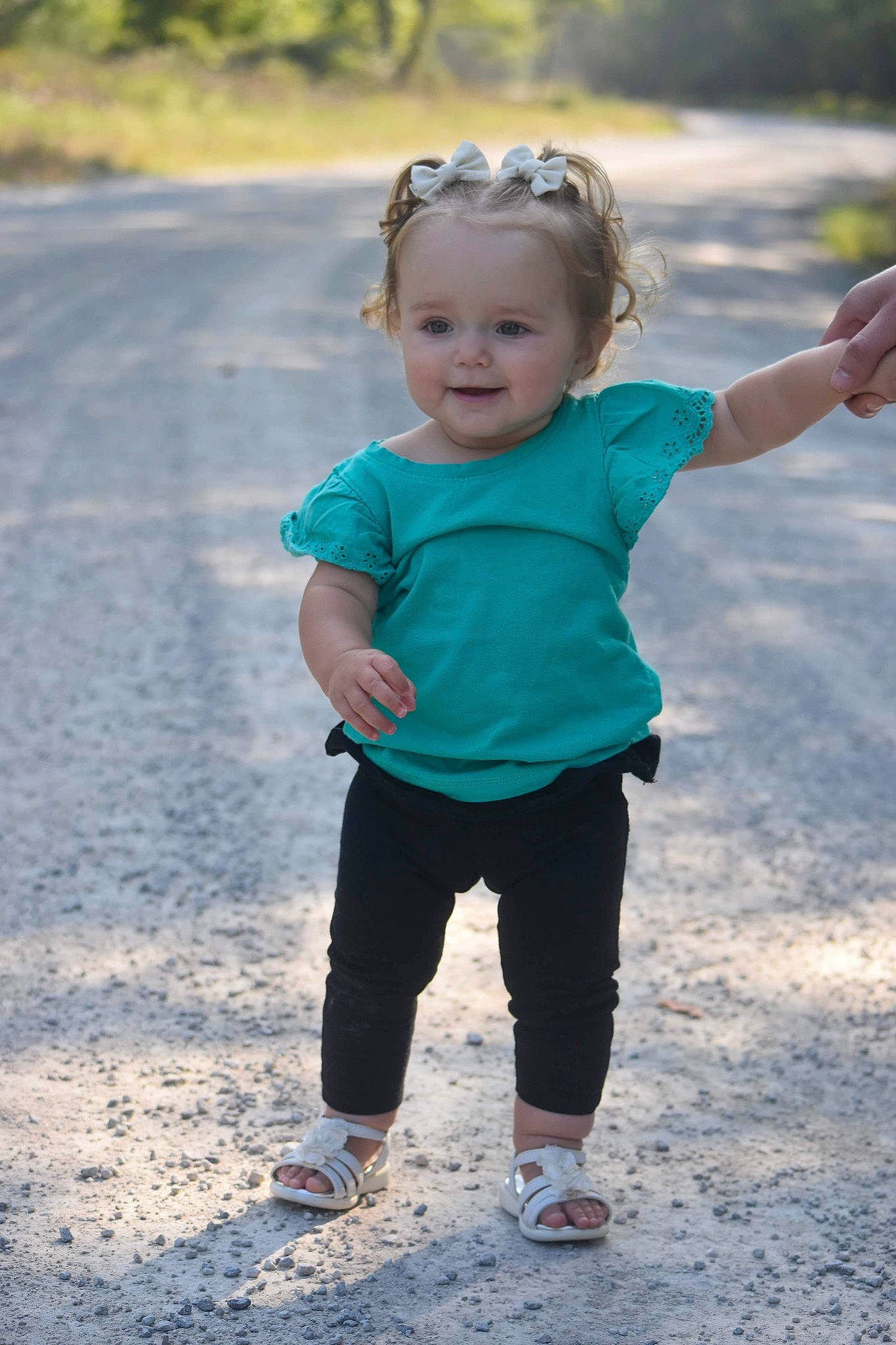 Remi is registered to the contest to win money with this photo: asphalt, baby_toddler_clothing, body_of_water, eye, face, gesture, grass, hand, happy, head, joy, leisure, people_in_nature, person, recreation, sleeve, smile, standing, summer, t_shirt