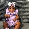 Serenity is registered to the contest to win money with this photo: baby, child, smile, bow, headwear, purple_outfit, socks, sitting, blanket, couch, happy, cute, indoors, infant, portrait, young_child, comfortable, soft_texture, clothing, person