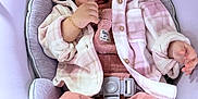 Abigail joined the competition — help win amazing prizes! baby, baby_seat, bracelet, child, comfort, cushion, cute, face, hand, happy, indoor, infant, jacket, pants, pastel_clothing, pink_hat, pom_poms, portrait, smile, warm