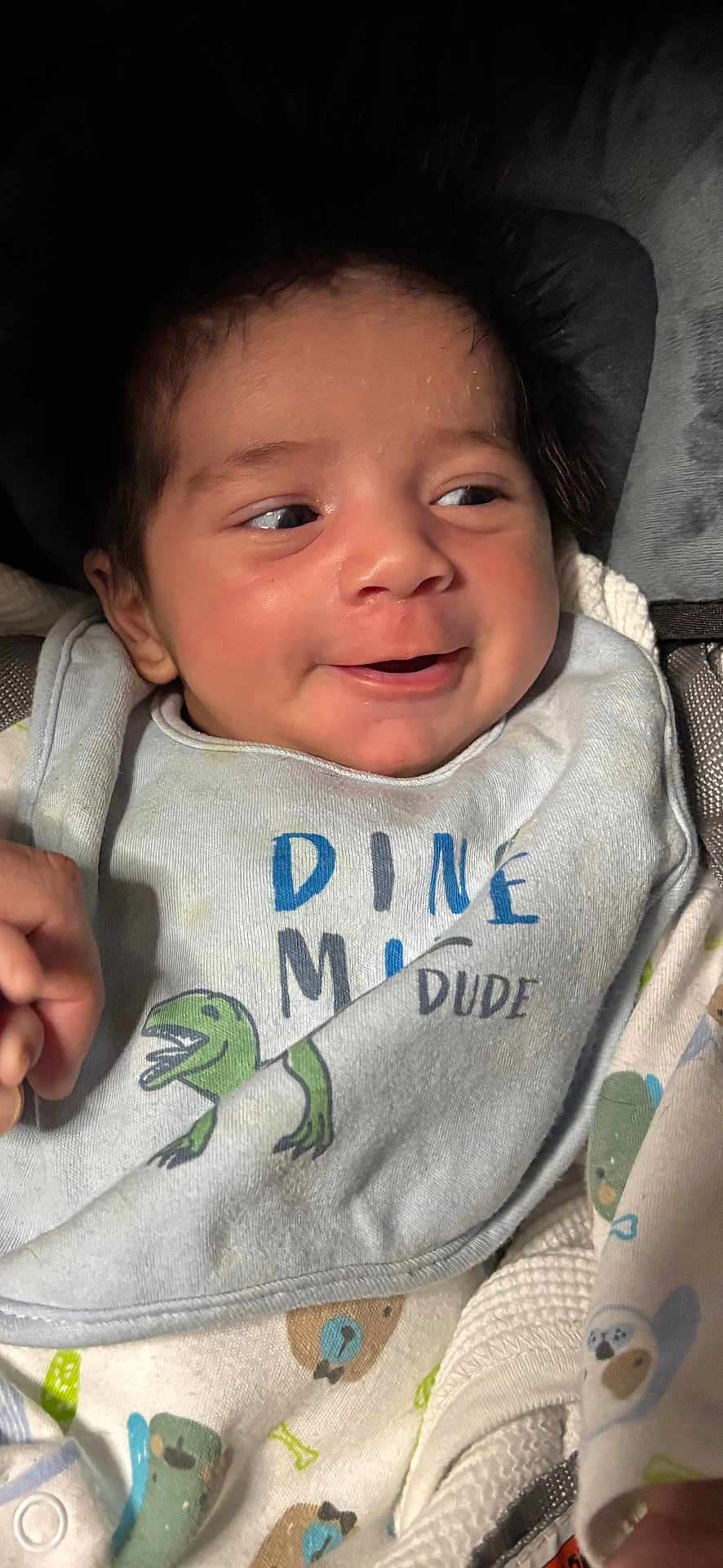 Draven joined the competition — help win amazing prizes! baby, infant, smile, face, clothing, bib, dinosaur, cute, happy, person, child, closeup, portrait, soft_lighting, indoors, baby_clothes, newborn, cozy, expression, wearing