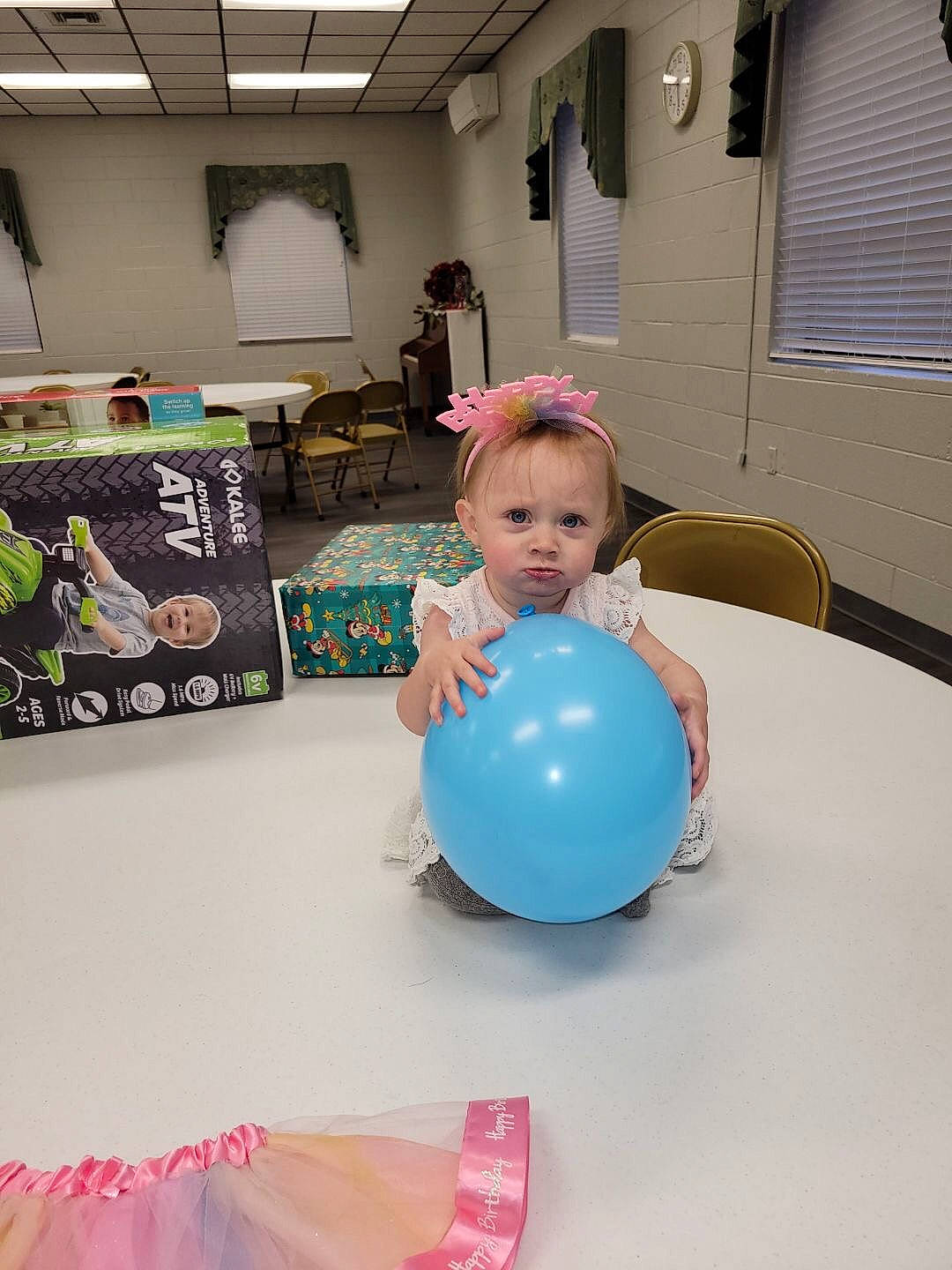 Adalynn is registered to the contest to win money with this photo: balloon, chair, child, electric_blue, event, flooring, fun, leisure, party, party_supply, person, pink, purple, recreation, room, sitting, t_shirt, table, toddler, window