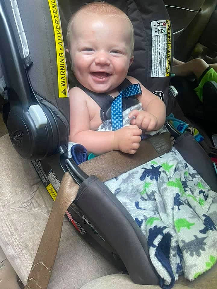 Watson is registered to the contest to win money with this photo: auto_part, baby, baby_carriage, baby_products, baby_toddler_clothing, bag, car_seat, child, comfort, electric_blue, face, happy, person, product, sitting, smile, snapshot, t_shirt, thumb, toddler