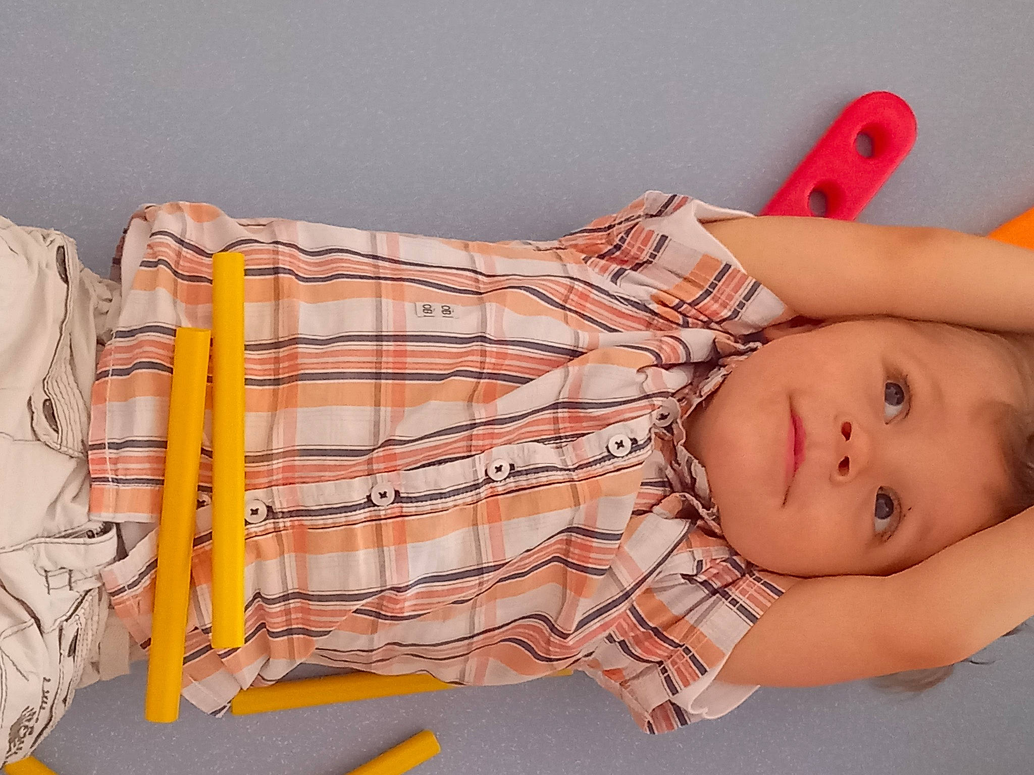 Gustave participe au concours pour gagner de l'argent avec cette photo : abdomen, arm, baby, baby_toddler_clothing, chest, comfort, elbow, finger, hand, human_body, joint, orange, pattern, person, plaid, sleeve, smile, tartan, textile, toddler