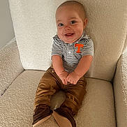 Graylen joined the competition — help win amazing prizes! armchair, baby, brown_shoes, chair, child, clothing, comfortable, cozy, cute, furniture, happy, indoor, infant, pants, person, portrait, sitting, smiling, striped_shirt, young_child