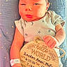 baby, birth_announcement, blanket, child, closeup, cute, face, hand, hospital_wristband, indoors, infant, newborn, onesie, person, plaque, portrait, resting, skin, sleeping, star_pattern