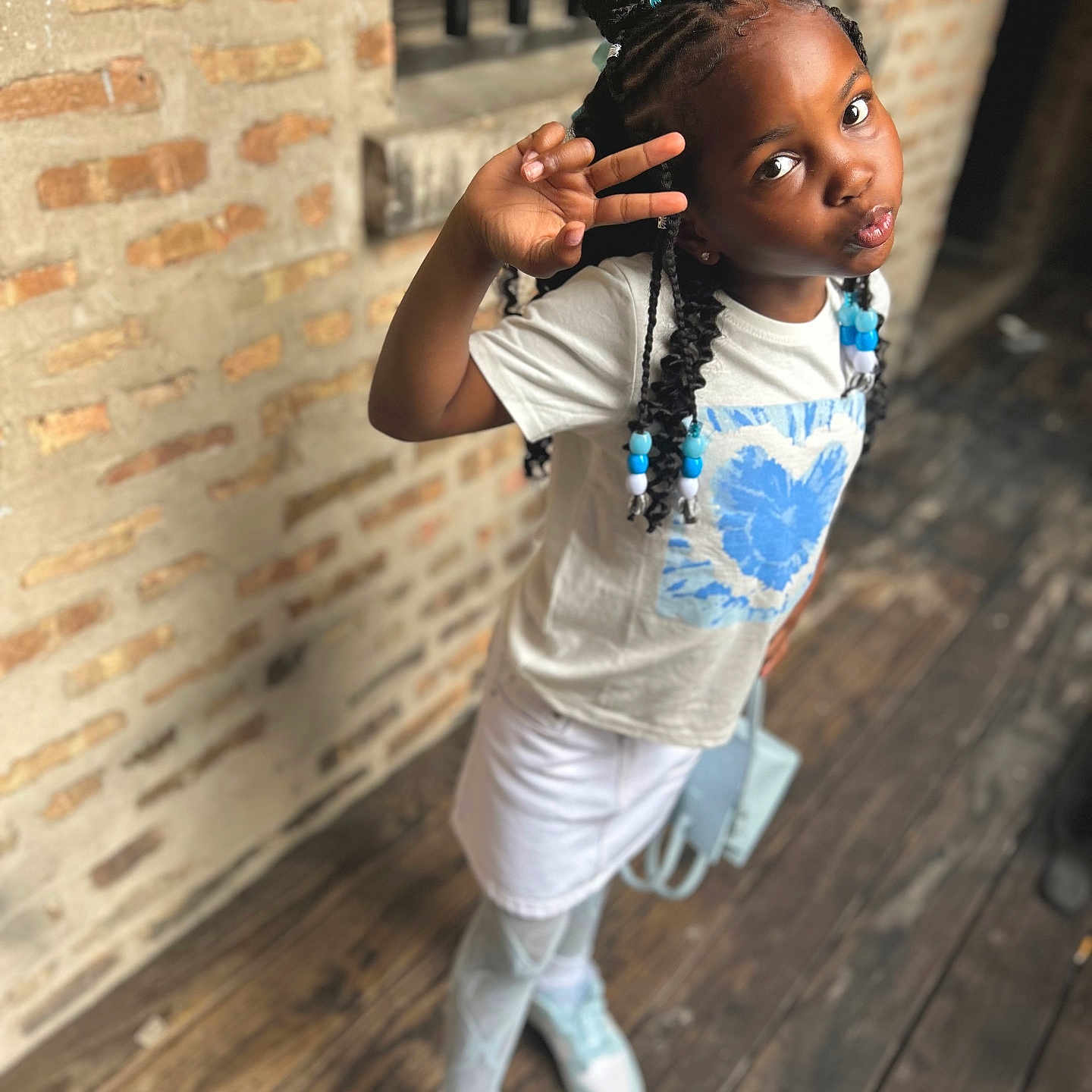 Kaylee joined the competition — help win amazing prizes! blackhair, braid, child, clothing, face, female, footwear, girl, hair, happy, hardwood, head, pants, person, shoe, sitting, sleeve, smile, student, wood
