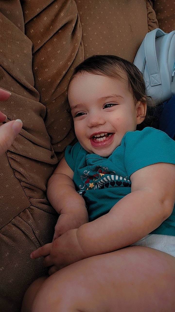 Eden is registered to the contest to win money with this photo: baby, baby_toddler_clothing, cheek, comfort, eye, facial_expression, finger, flash_photography, fun, hairstyle, happy, iris, joy, mammal, mouth, person, pink, product, skin, smile