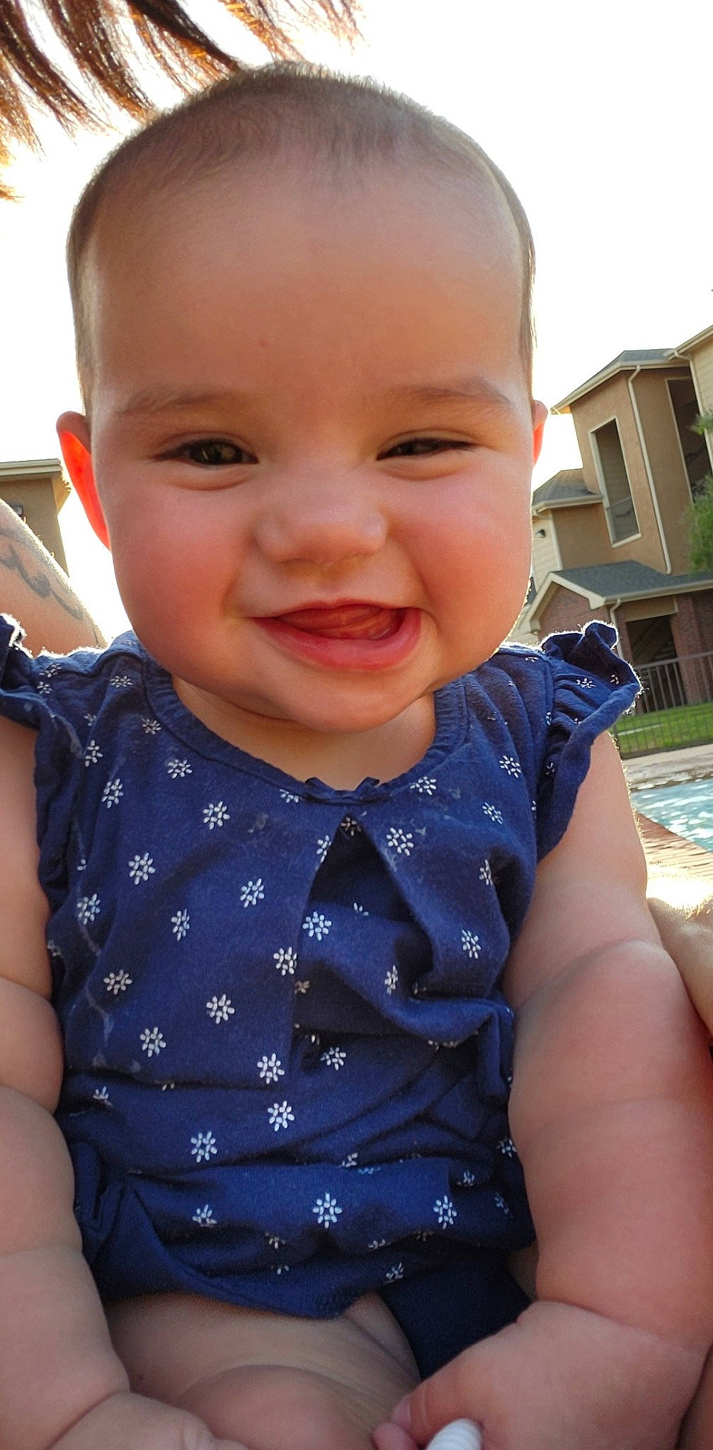 Eden is registered to the contest to win money with this photo: arm, baby, baby_toddler_clothing, cheek, chin, collar, cool, facial_expression, happy, head, iris, joy, lip, neck, nose, person, plant, skin, sleeve, smile