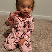 Valentina is registered to the contest to win money with this photo: child, toddler, pajamas, pink, carpet, indoor, kneeling, waving, girl, hair_bows, cute, smile, face, person, clothing, sleepwear, mickey_mouse, home, young_child, portrait