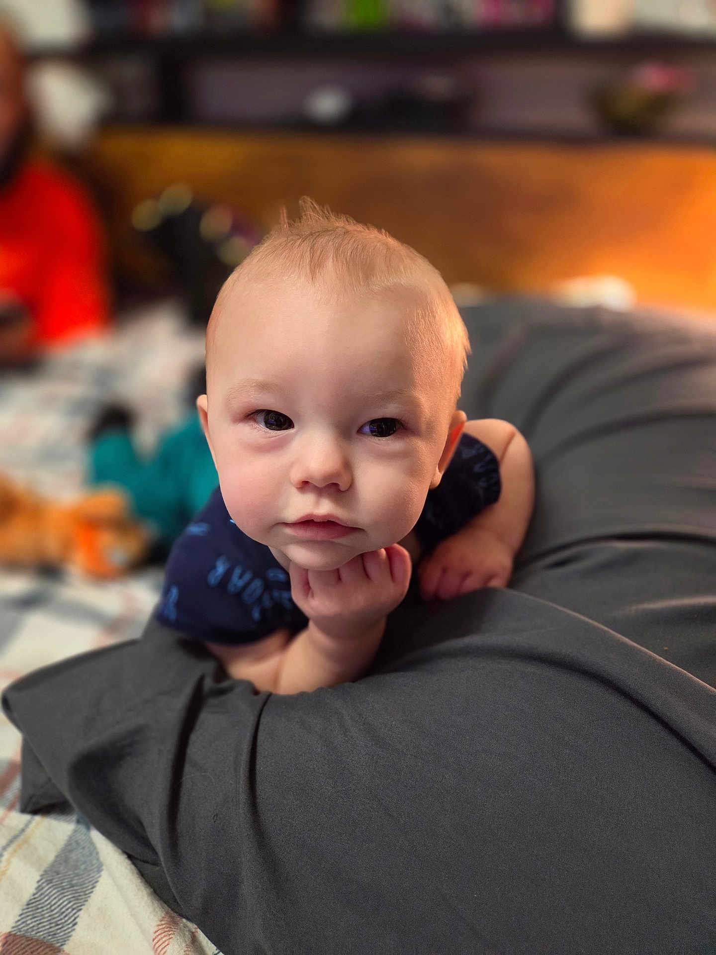 Wayne is registered to the contest to win money with this photo: baby, infant, portrait, closeup, eyes, chubby_cheeks, hand, tummy_time, pillow, blanket, bed, indoor, bokeh, shallow_depth_of_field, soft_lighting, neutral_expression, adorable, clothing, head, skin