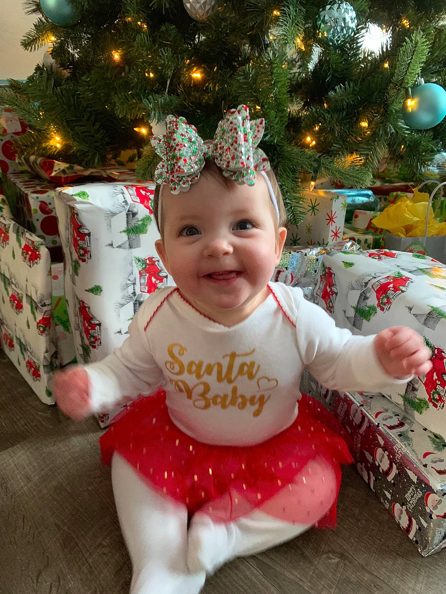 Kinsley is registered to the contest to win money with this photo: baby, baby_toddler_clothing, christmas, christmas_decoration, christmas_eve, christmas_ornament, christmas_tree, conifer, costume_accessory, happy, headwear, holiday, holiday_ornament, home_accessories, human, human_body, interior_design, joy, mouth, nose