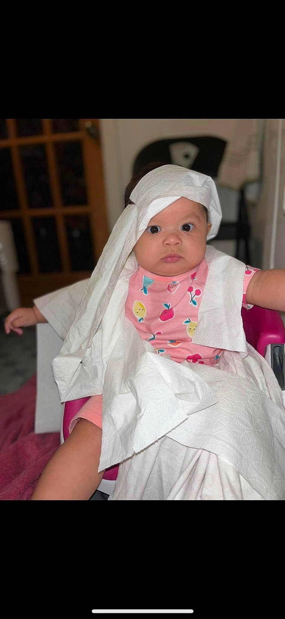 Gabriella joined the competition — help win amazing prizes! baby, baby_products, baby_toddler_clothing, bridal_clothing, child, costume, dress, event, fashion_accessory, flash_photography, fun, gesture, hair_accessory, happy, headwear, magenta, person, pink, sitting, skin