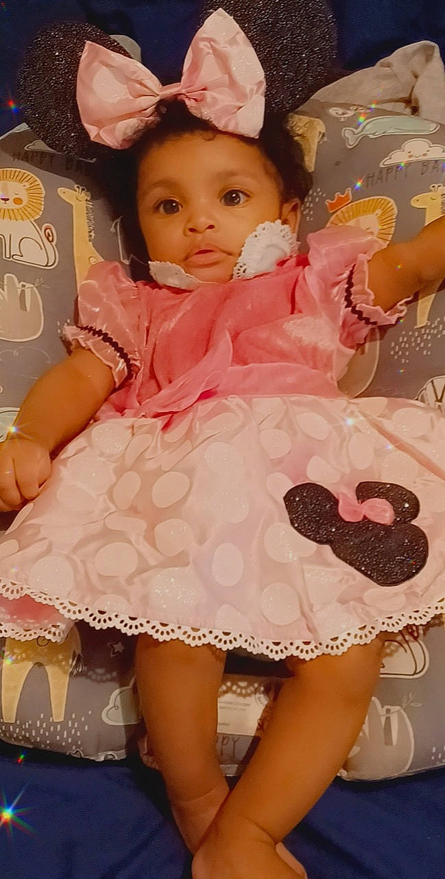 Ja'Yanna is registered to the contest to win money with this photo: baby_toddler_clothing, cheek, day_dress, dress, embellishment, face, fashion, finger, happy, lip, one_piece_garment, person, pink, product, skin, sleeve, textile, thigh, toddler, white