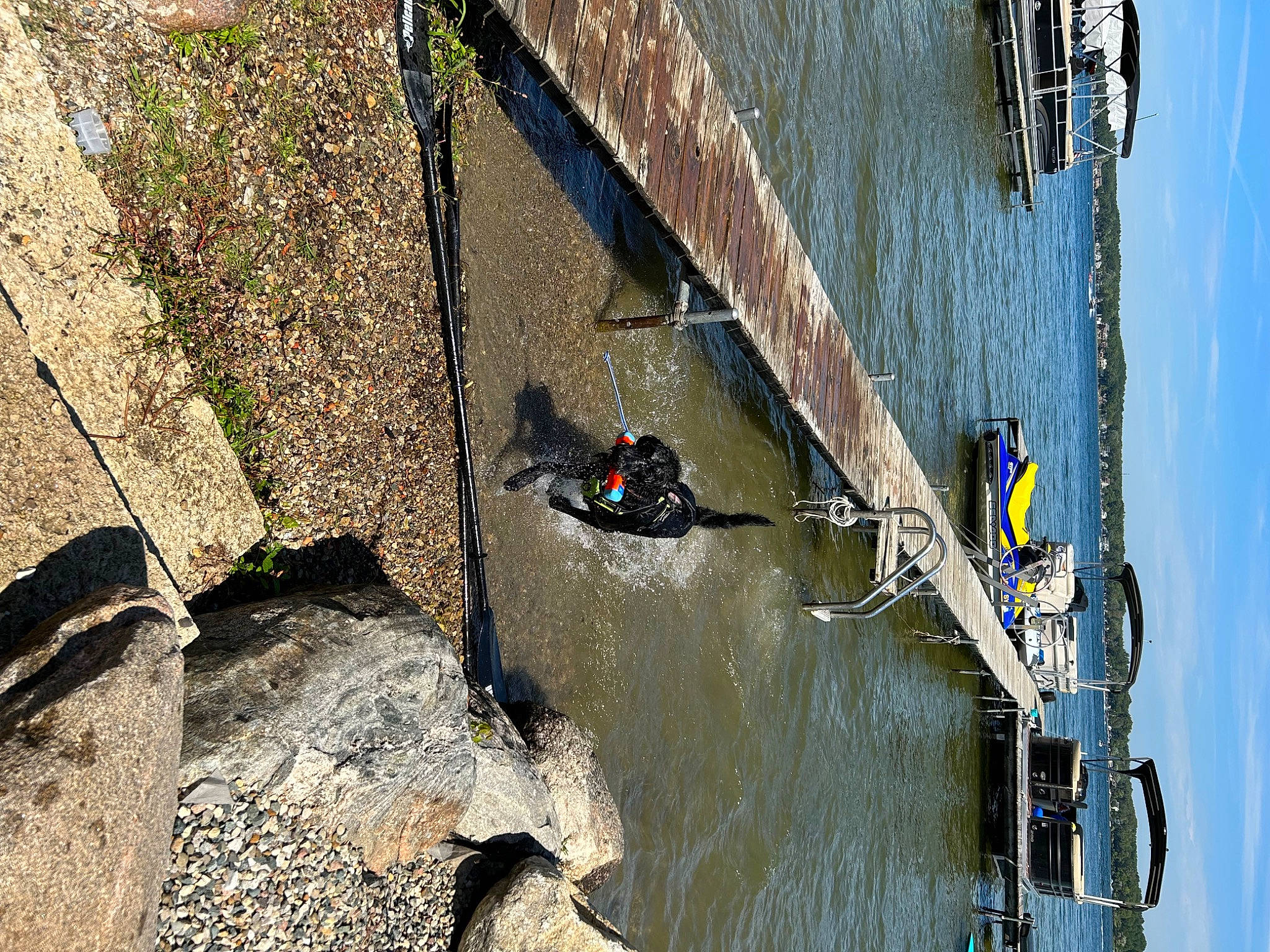 Gus is registered to the contest to win money with this photo: boat, boats_and_boating_equipment_and_supplies, bridge, canal, channel, geological_phenomenon, lake, landscape, line, plant, recreation, reflection, reservoir, sky, vehicle, water, water_resources, watercourse, watercraft, wood