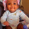 Alora joined the competition — help win amazing prizes! apparel, baby, bonnet, child, couch, cute, dimples, expression, face, happy, headwear, indoor, infant, onesie, person, portrait, sitting, skin, smiling, young