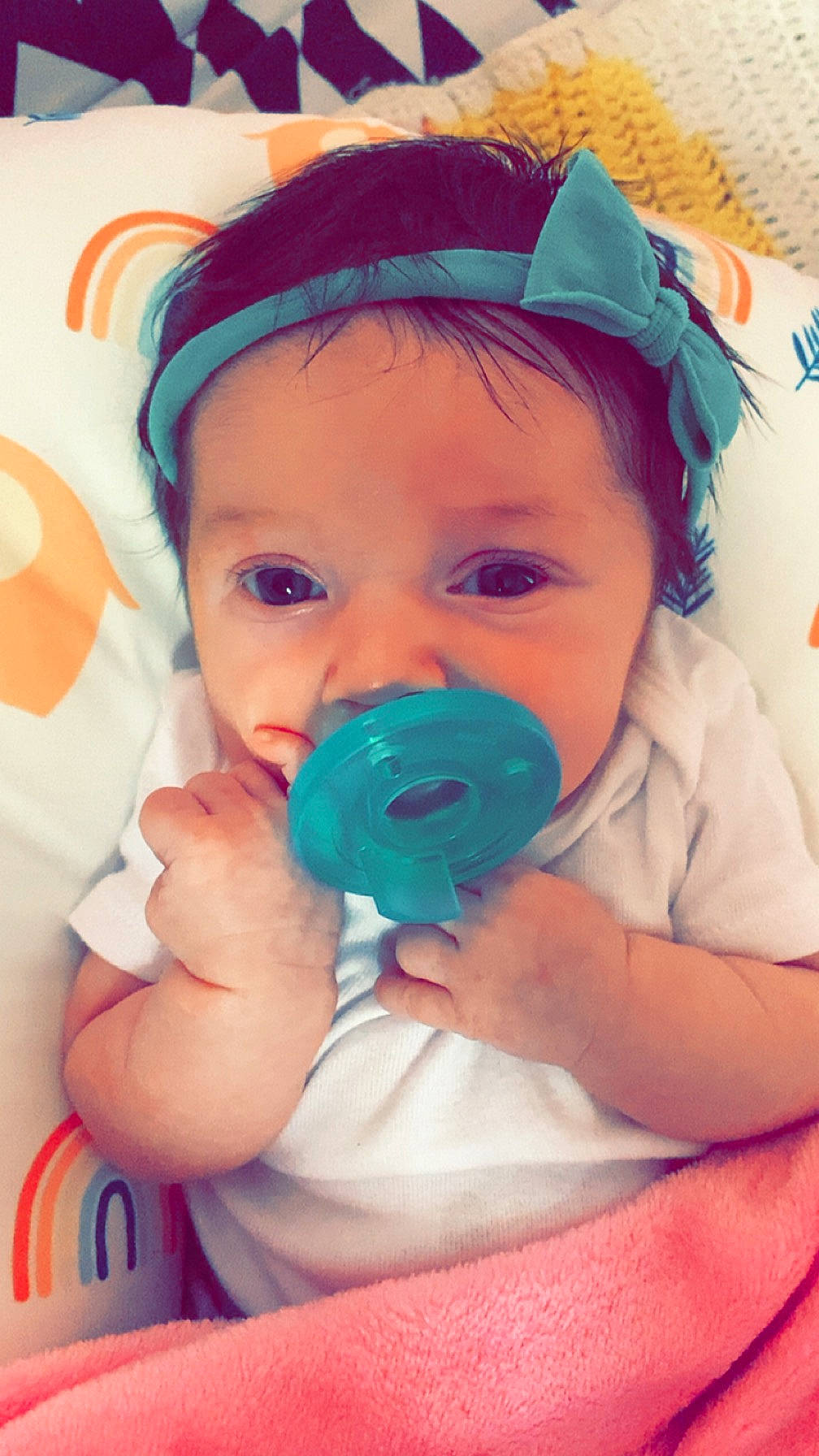 Miah is registered to the contest to win money with this photo: arm, baby, baby_toddler_clothing, cheek, clothing, cool, eyelash, face, facial_expression, finger, hairstyle, hand, happy, iris, lip, mouth, nose, person, pink, skin