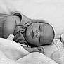 Eden a rejoint le concours — aidez-le/la à gagner de superbes lots ! baby, sleeping, blanket, soft, cozy, infant, face, resting, peaceful, black_and_white, closeup, portrait, couch, clothing, hand, head, texture, comfort, serene, indoor