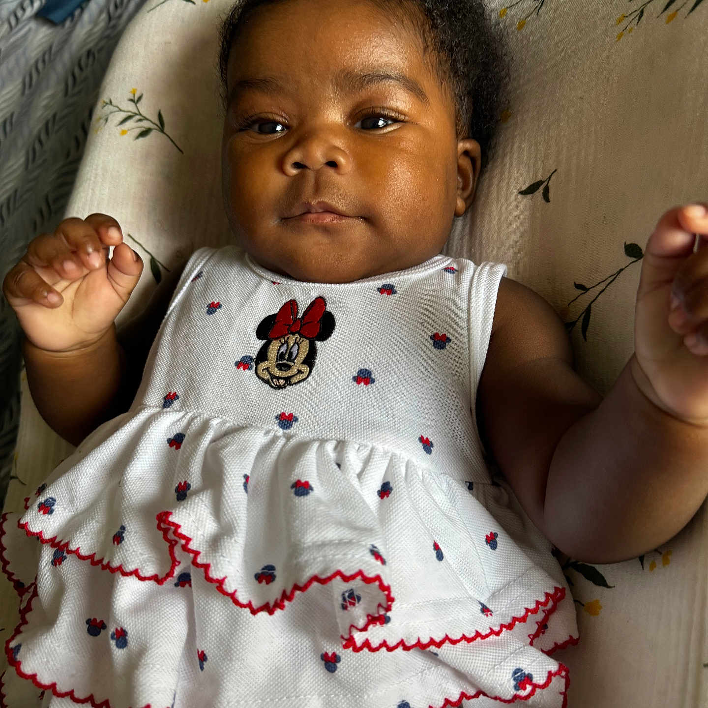 Mayendjie is registered to the contest to win money with this photo: baby, child, infant, dress, white_dress, minnie_mouse, frills, cushion, floral_pattern, indoor, portrait, cute, adorable, relaxed, skin, hand, face, eyes, hair, smile